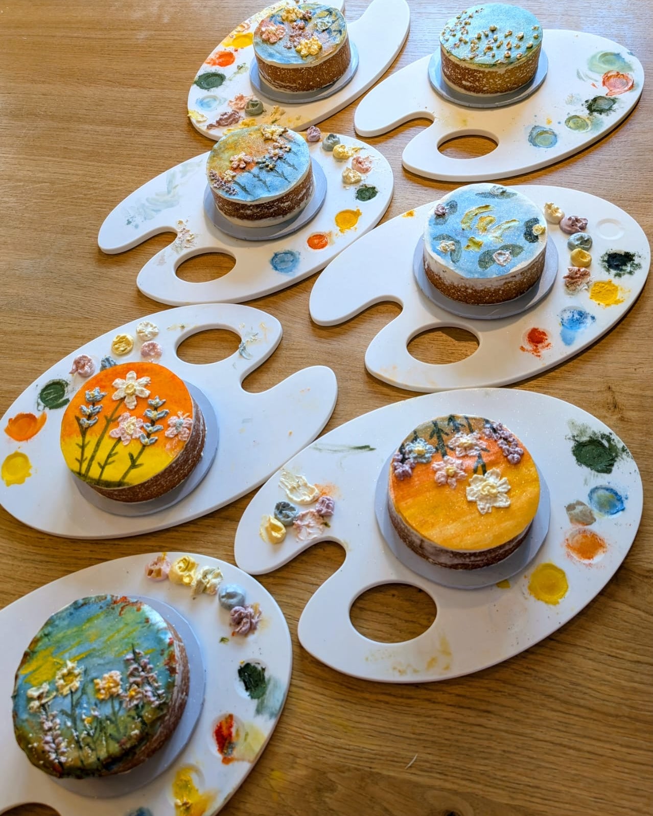 Buttercream cakes hand-painted with edible watercolour, displayed on Prop Options cake paint palette boards