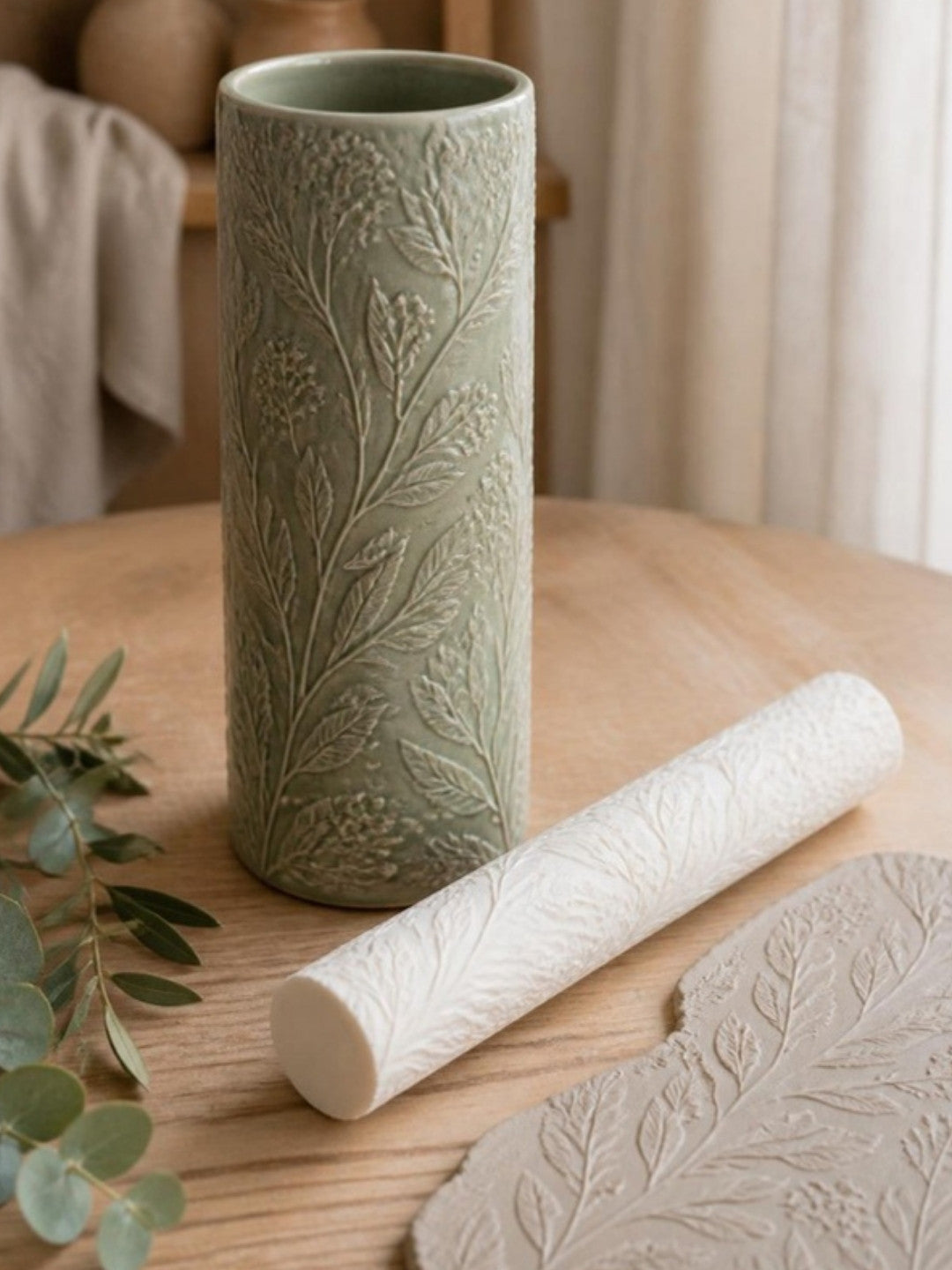 Glazed stoneware vase with botanical texture made with a Prop Options 9 inch clay texture roller, no carving