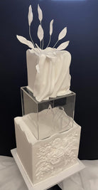 Clear acrylic square fillable cake separator by Prop Options shown close up