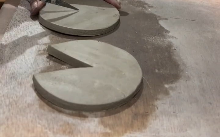 Karen Wiltshire cutting a V from clay discs for the sphere split mould