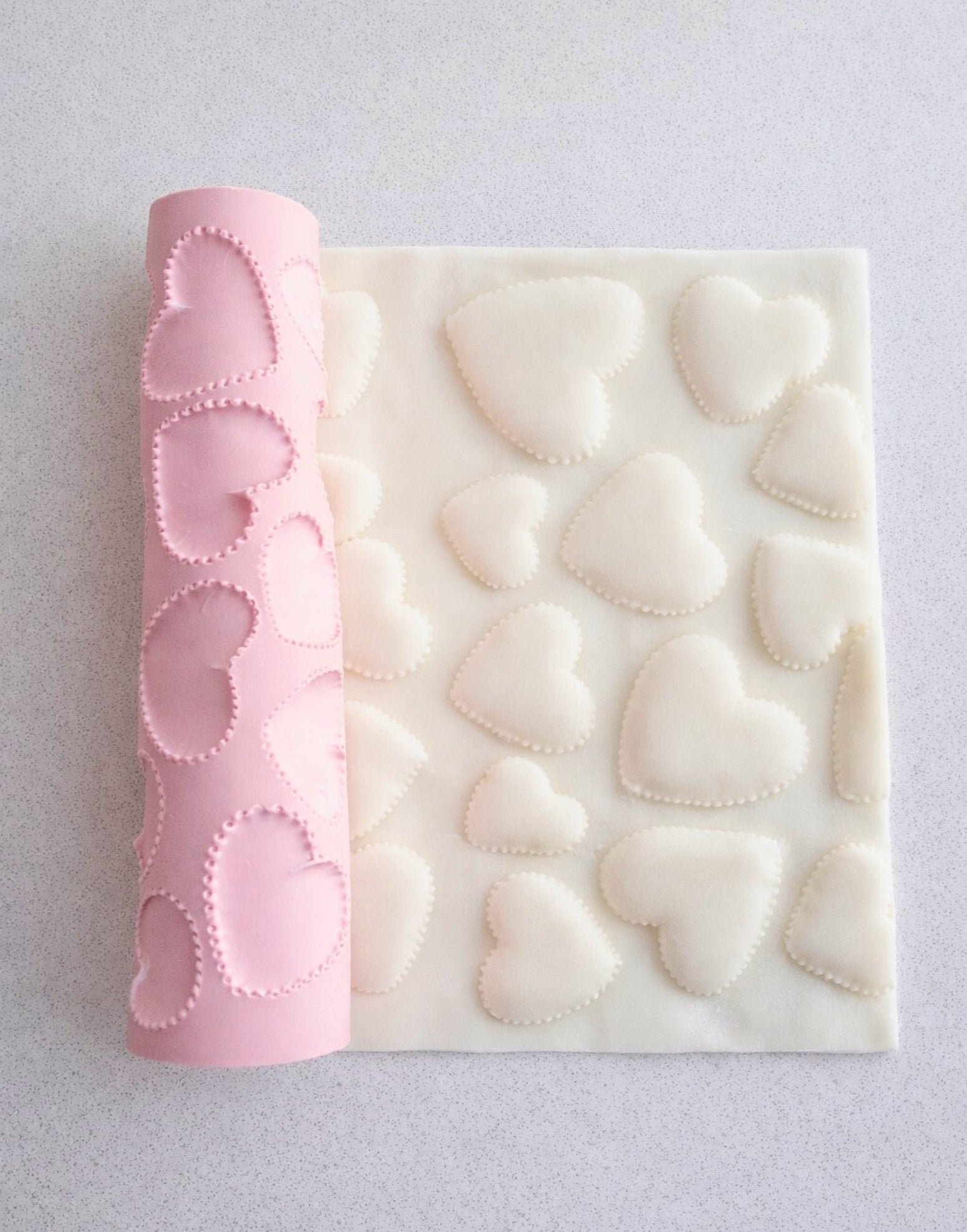 Hearts texture rolling pin by ML Bespoke Cakes creating stitched heart pattern on fondant