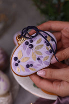 Lilac leaf bauble cookie with a navy ribbon